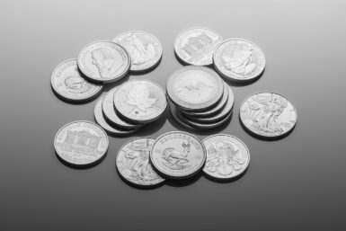 silver round coins on white surface