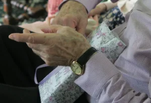 person wearing round gold-colored framed analog watch