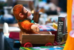 a stuffed toy monkey sitting on a stack of books