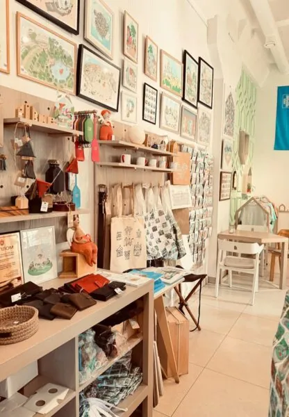 A cozy shop interior with handmade goods and framed artwork